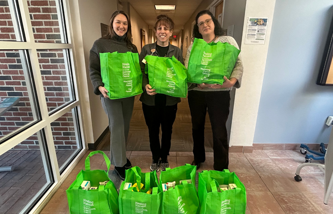 Pictured: Dartmouth Cancer Center Bennington Administrative Director Caryn Packard, Nutritionist Kristin Irace, RD, LDN and Oncology Social Worker Elizabeth Fredland, LICSW, with patient food bags from Healing Harvest.