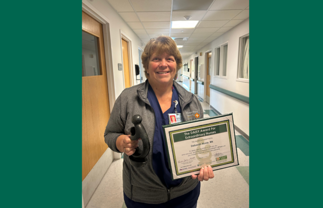 Deborah Mone holds her DAISY award and recognition